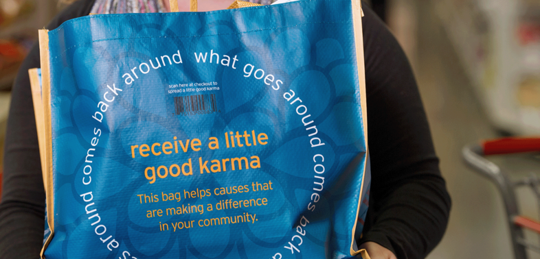 A shopping bag with the text " Receive good karma" and "What comes around comes back around".