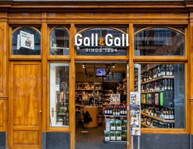 Old Gall & Gall sore with a wood window frame and a logo above the entrance.