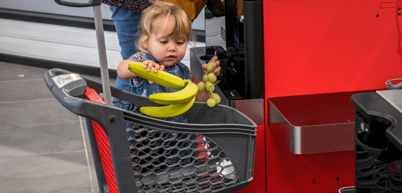 a child sitting in a shopping cart from Delhaize Belgium.